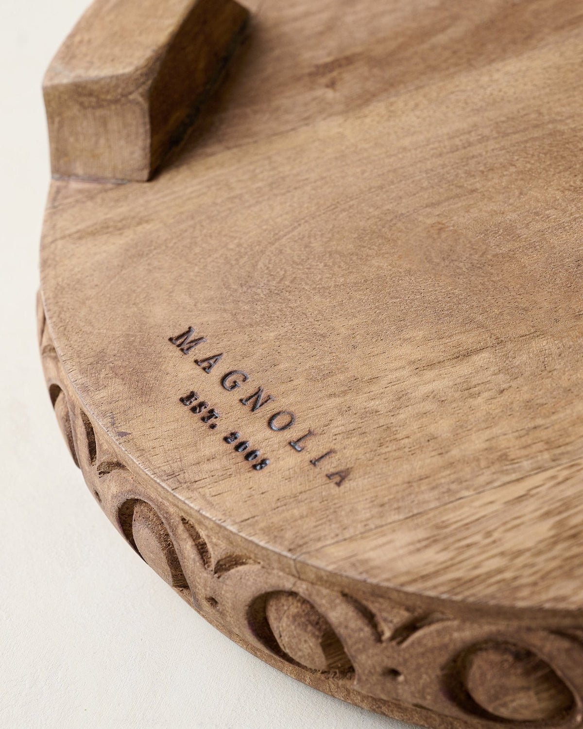 Mavelle Antiqued Carved Wood Round Riser decorative accent - Styled in Room