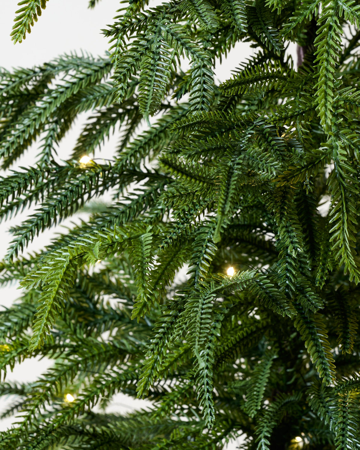 Mavelle Real Touch Norfolk Pine Pre-Lit Potted Tree faux floral stem - Close-Up